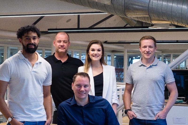 a group of people standing in an office
