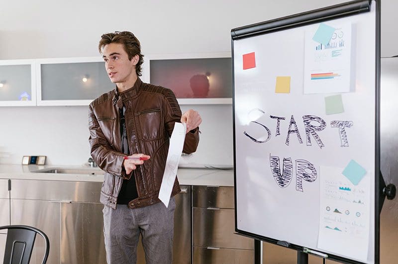 A person explaining using a white board