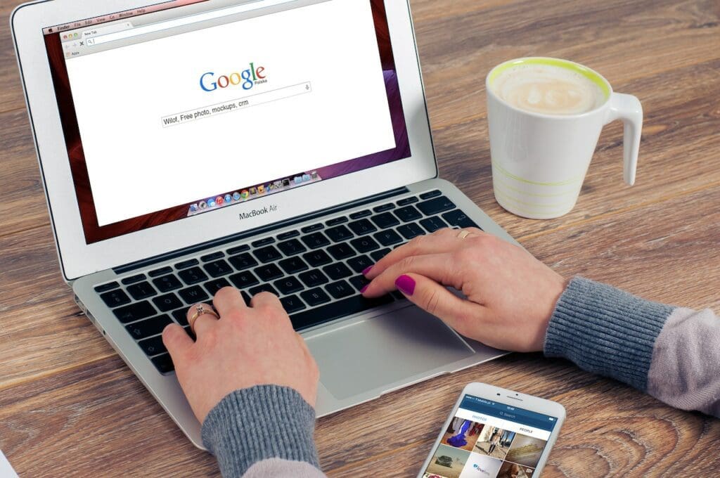 man serarching on google in laptop